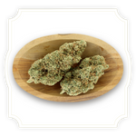 Load image into Gallery viewer, Mela Sour CBD flower close up in wooden bowl on white background
